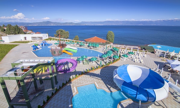 A resort with a large pool area, water slides, and beach chairs. - Hotel Izgrev Spa & Aqua Park (Struga)