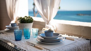 A table set with plates, bowls, glasses, and cutlery, overlooking a body of water. - Holiday Home "Nicoleup" with Sea View, Terrace & Shared Garden (Perd'e Sali)