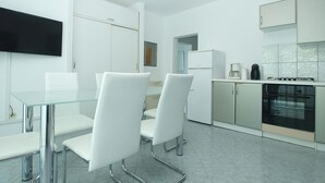 A modern kitchen with white cabinets, a built-in oven, and a coffee maker. - Apartment 56/34816 (Istria - Stinjan), 1000m from the beach (Stinjan)