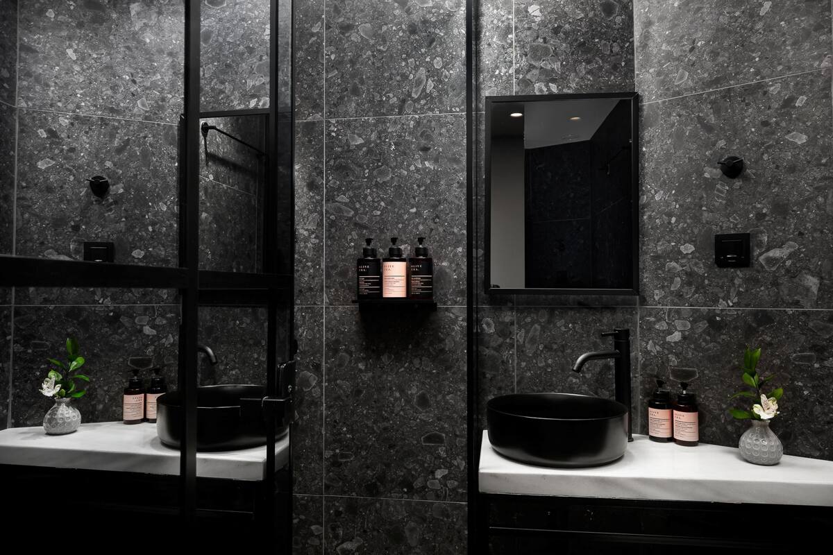 Een douche, een hydromassagedouche, pantoffels, handdoeken
