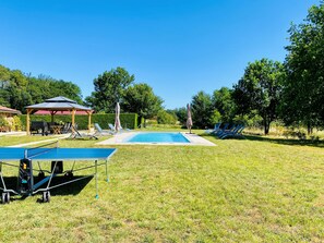 A swimming pool with lounge chairs and a pavilion in a grassy area. - Two Historic Holiday Homes in the Dordogne — Each with a Private Heated Pool (Capdrot)