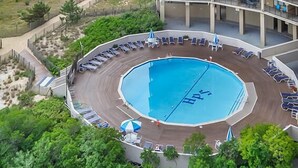 A high-rise hotel with a rooftop pool, beach view, and multiple balconies. - Beautiful 2-bedroom oceanfront condo with gorgeous ocean views, free WiFi, and an outdoor pool located uptown with direct access to the beach! (Ocean City)