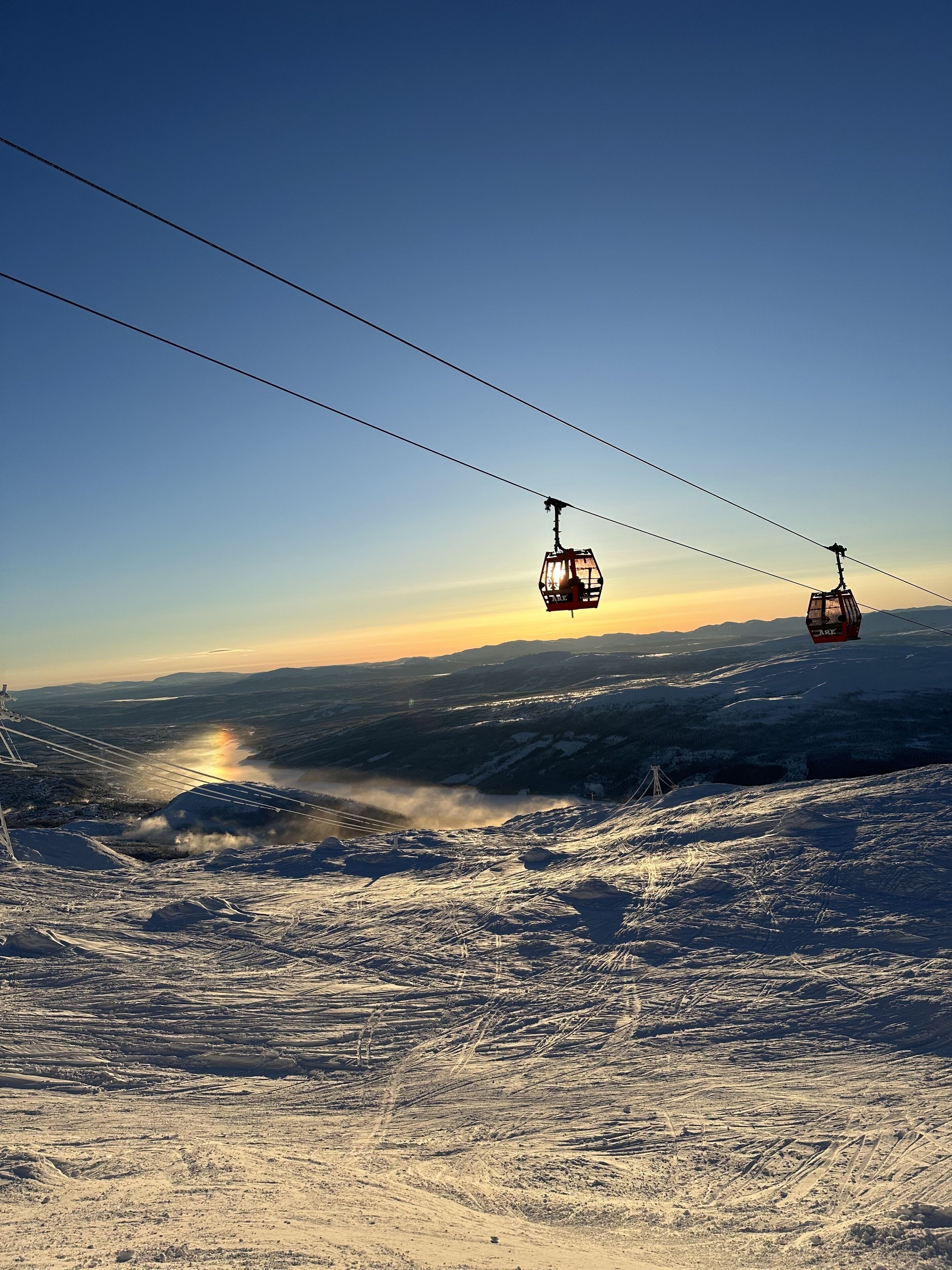 A cable car system with a mountainous landscape in the background.