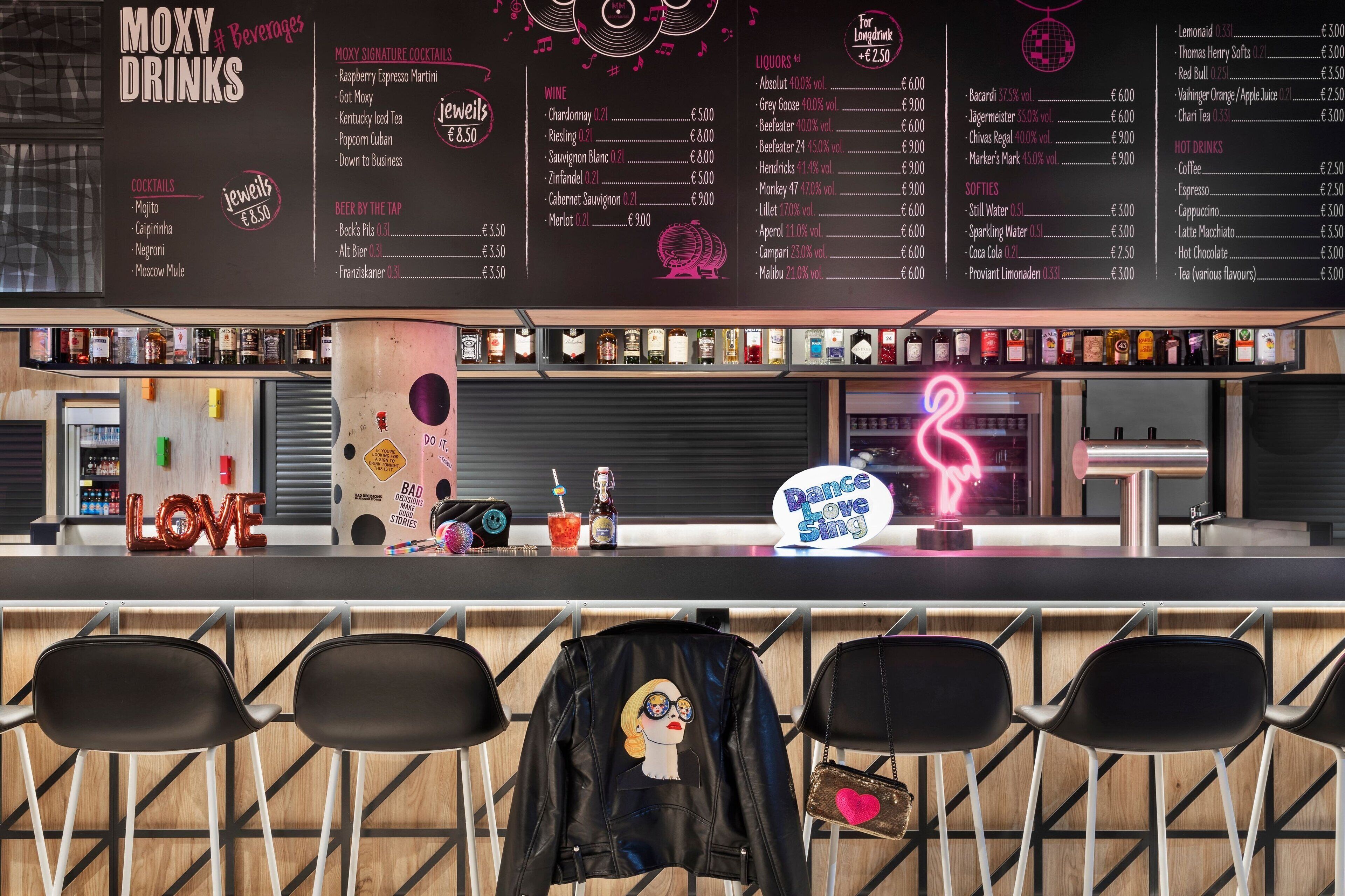 A bar area with a menu listing various drinks and cocktails.