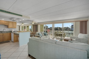 A spacious living area with a sofa, a dining table, and a kitchen area.