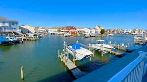 A marina with boats docked at wooden piers, surrounded by residential buildings.