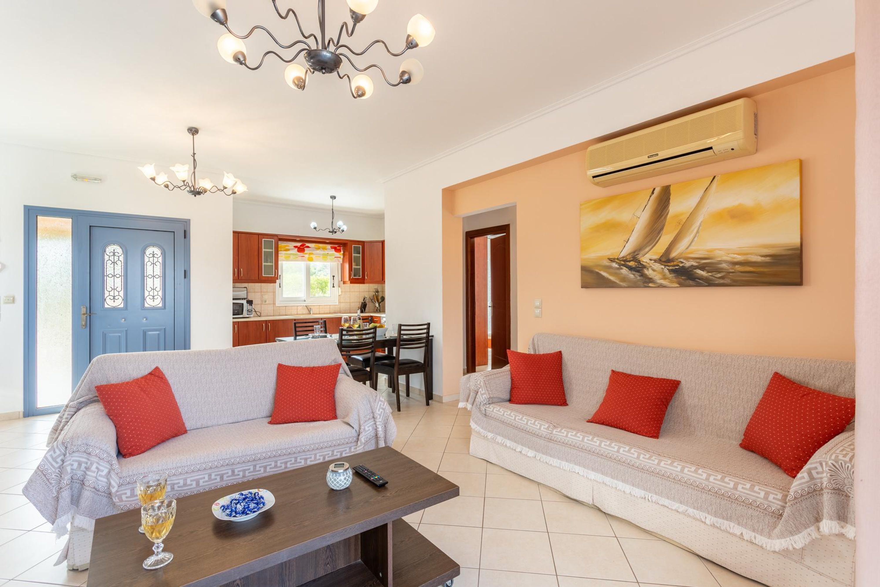 A living room with two sofas, a coffee table, and a dining area.