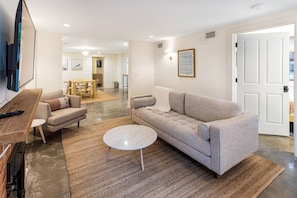 Relax in this inviting living room with a comfortable sofa, coffee table, and wall-mounted TV.
