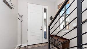 A staircase with a metal railing leading to a landing.