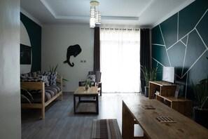 TV, fireplace - The Green Sanctuary - Art Nouveau (Kigali)