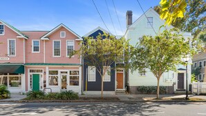 A row of colorful townhouses with a green door, a for lease sign, and a tree in front. - Only 2 Blocks to King! | The Murray (Charleston)