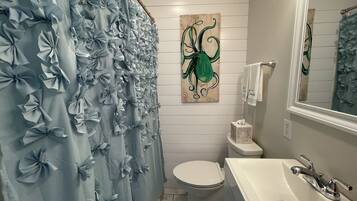 Bathtub, hair dryer, towels, soap