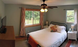 A bedroom with a bed, a ceiling fan, a window, and a nightstand. - Private Home & Yard ~ Hiking, Creek & River Nearby! (Chattanooga)