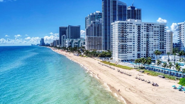 A beachfront hotel with multiple high-rise buildings, a sandy beach, and clear blue waters. - 97-B Free Parking! Beautiful Oceanfront Condo! (Hollywood)