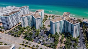 A high-rise hotel with multiple floors, a parking lot, and a beach view. - 97-B Free Parking! Beautiful Oceanfront Condo! (Hollywood)