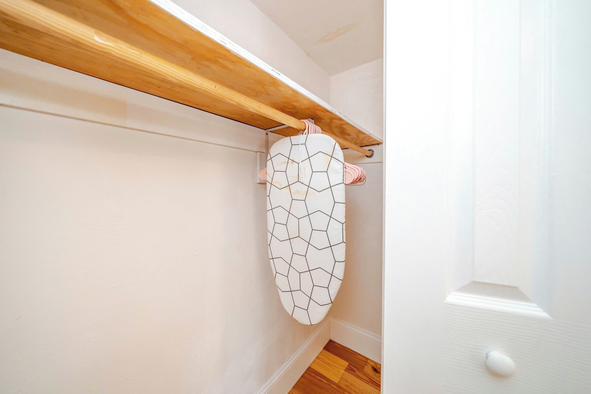 A corner with a wooden beam, a white wall, and a white door.