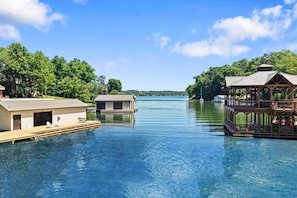 A clear view of a lake with floating structures, including a dock and a gazebo.