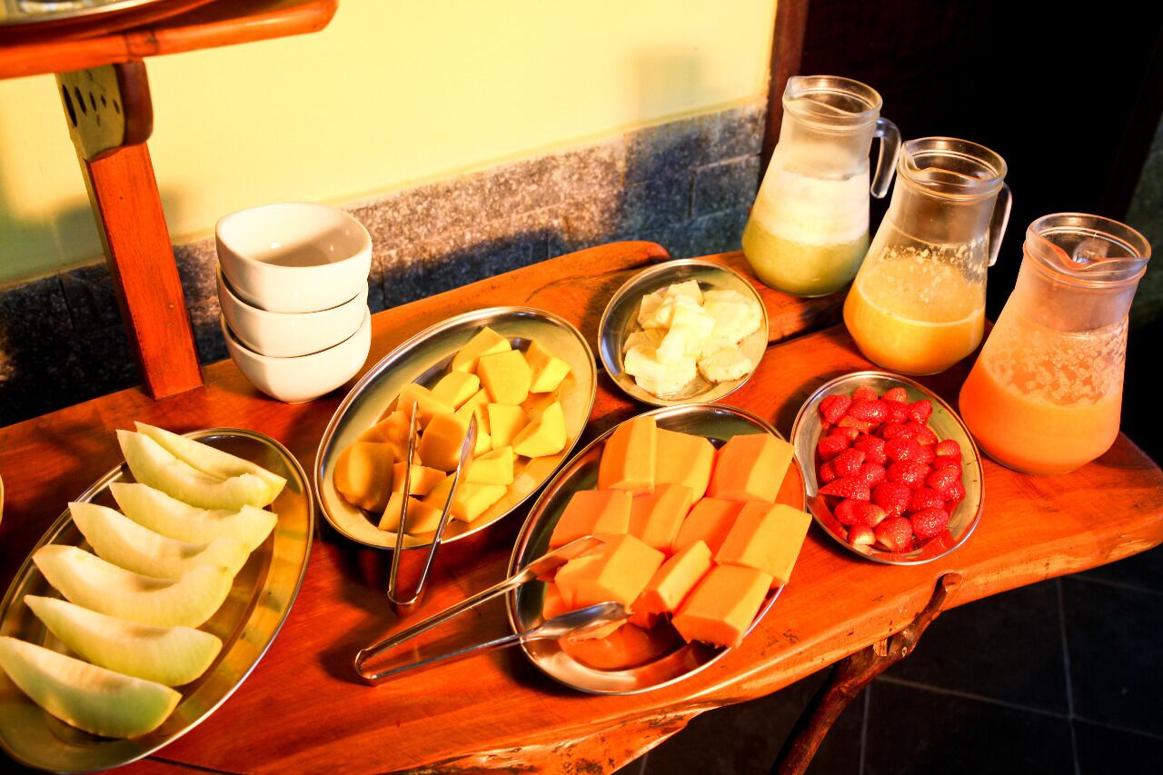 A breakfast buffet with various fruits and beverages.