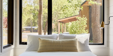 Premium bedding, down comforters, Tempur-Pedic beds, in-room safe. AutoCamp Catskills