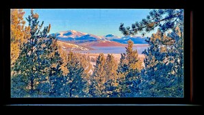 A mountainous landscape with snow-capped peaks and a lake in the background. - Custom log cabin tucked away in private forest (Hartsel)