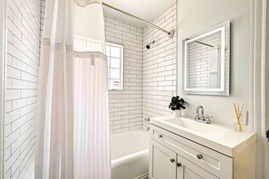 Combined shower/bathtub, towels, soap, toilet paper