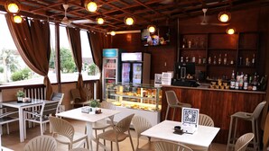 A restaurant with outdoor seating, a bar area, and a refrigerated display case.