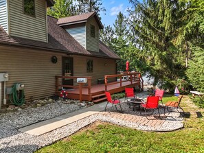 A house with a deck, outdoor seating, and a mailbox.