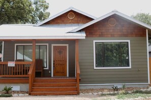 A two-story house with a front porch, a wooden door, and a window with blinds. - Downtown Duplex-San Antonio Unit #2 (San Antonio)