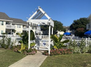 garden oasis with a charming white picket fence and a serene pergola.