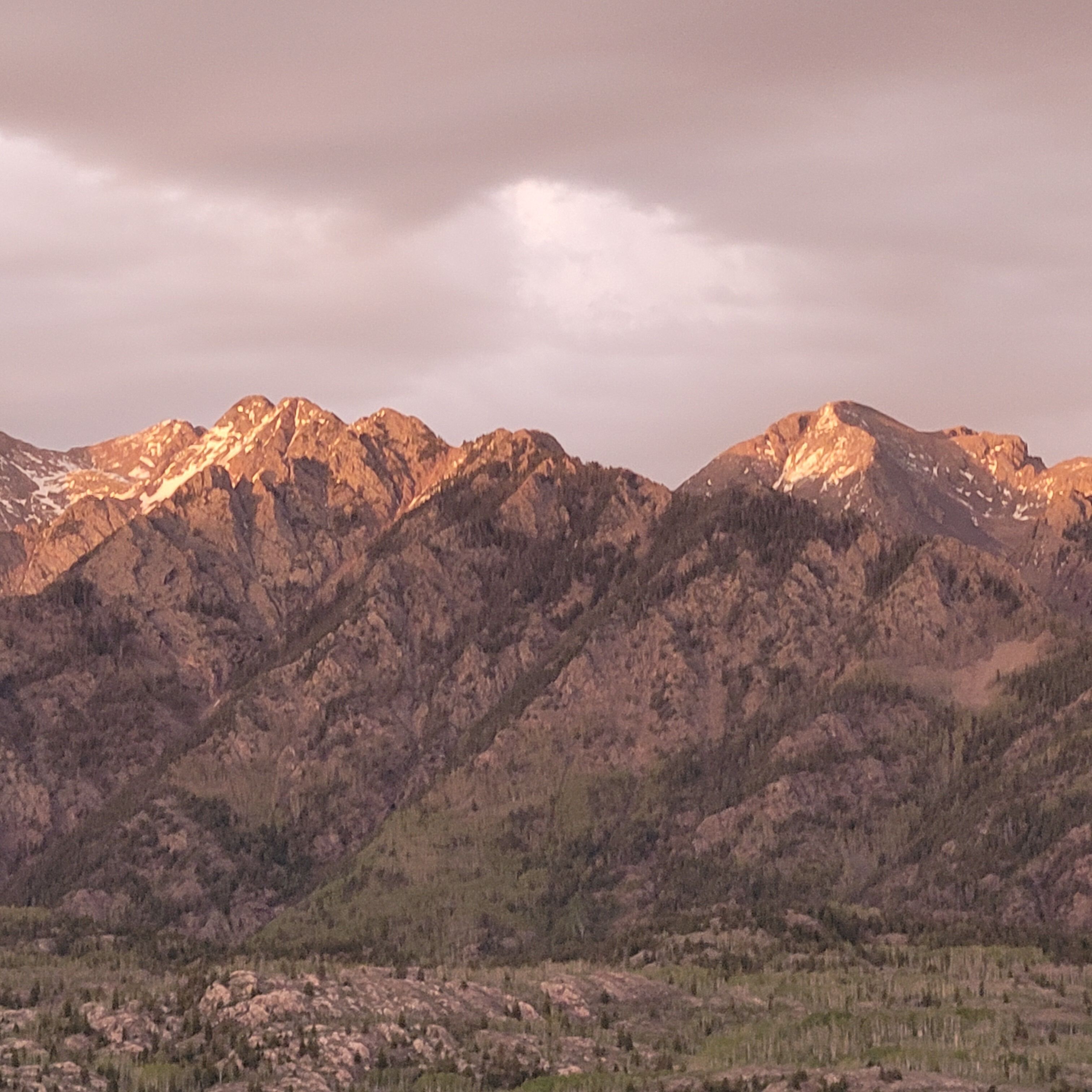 A mountainous landscape with rugged terrain and sparse vegetation.