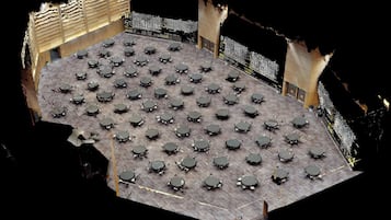 A large, open-plan area with numerous tables and chairs arranged in a grid pattern, likely a dining or meeting space.