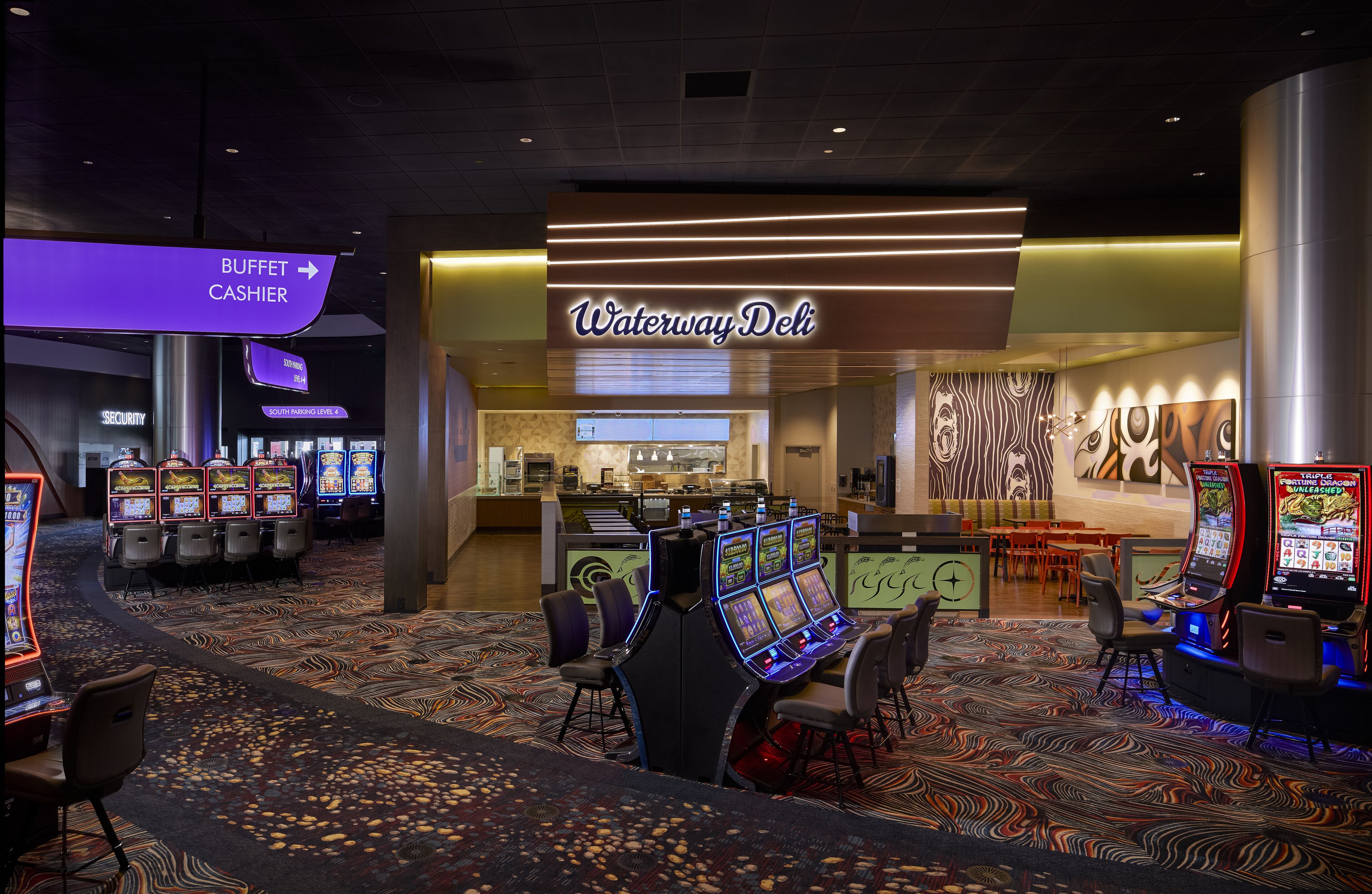 A casino area with multiple slot machines, a buffet, and a cashier.