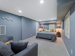 Relax in this serene bedroom with a large bed, bedside tables, and lamps.