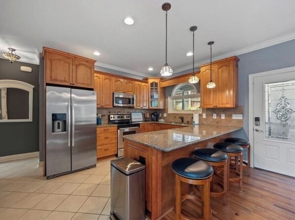 Enjoy cooking in this well-equipped kitchen with a central island and bar stools.