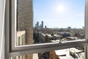 A cityscape view from a high-rise building with a clear sky.