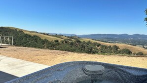 A hot tub with a control panel, surrounded by a view of rolling hills and a clear sky. - Close to Wineries/Hot Tub/Vineyard View/Dog Okay! (Templeton)