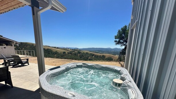 A hot tub on a patio with a view of rolling hills. - Close to Wineries/Hot Tub/Vineyard View/Dog Okay! (Templeton)