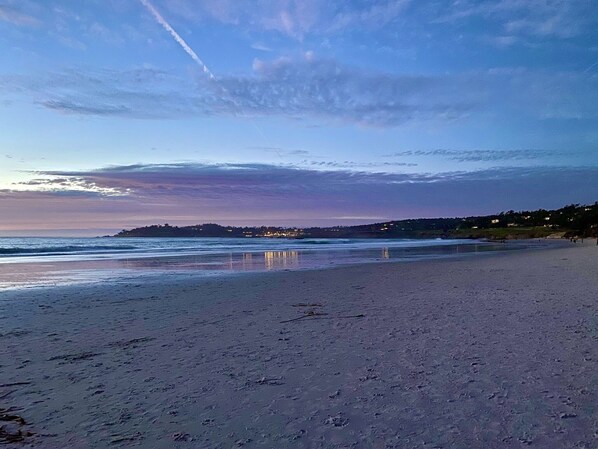 A beach with a clear sky and distant shoreline.