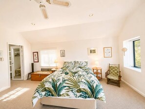 A bedroom with a bed, bedside tables, a chair, a window, and a ceiling fan. - The Bawley Hideaway - Modern Bawley Point hideaway near beach (Bawley Point)