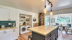 A modern kitchen with a central island, built-in appliances, and a view of the outdoors. - Cozy Retreat w/ Deck ~ 2 Mi to Pinecrest Lake! (Strawberry)