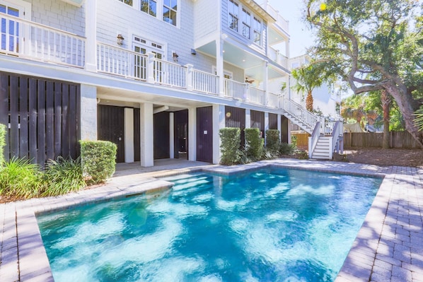 A two-story building with a swimming pool in front.