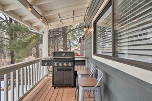 Enjoy al fresco dining on the deck with a grill and comfortable seating.