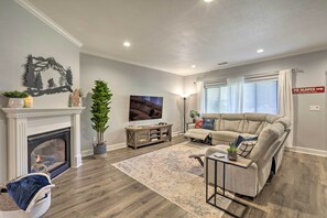 Cozy living room with a fireplace, sofa, and TV, perfect for relaxing.