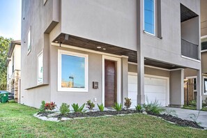 Stylish two-story residence with a flat roof, large windows, and a clean facade.