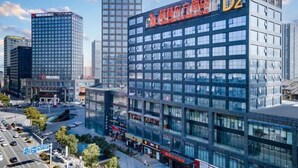 A modern hotel building with a prominent sign, surrounded by high-rise buildings and a busy street. - Greentree Eastern Tongling City Beijing West Road Big Dipper City Hotel (Tongling)