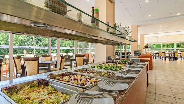 A buffet with various food options and utensils. - Hotel Gloria - All Inclusive (Varna)