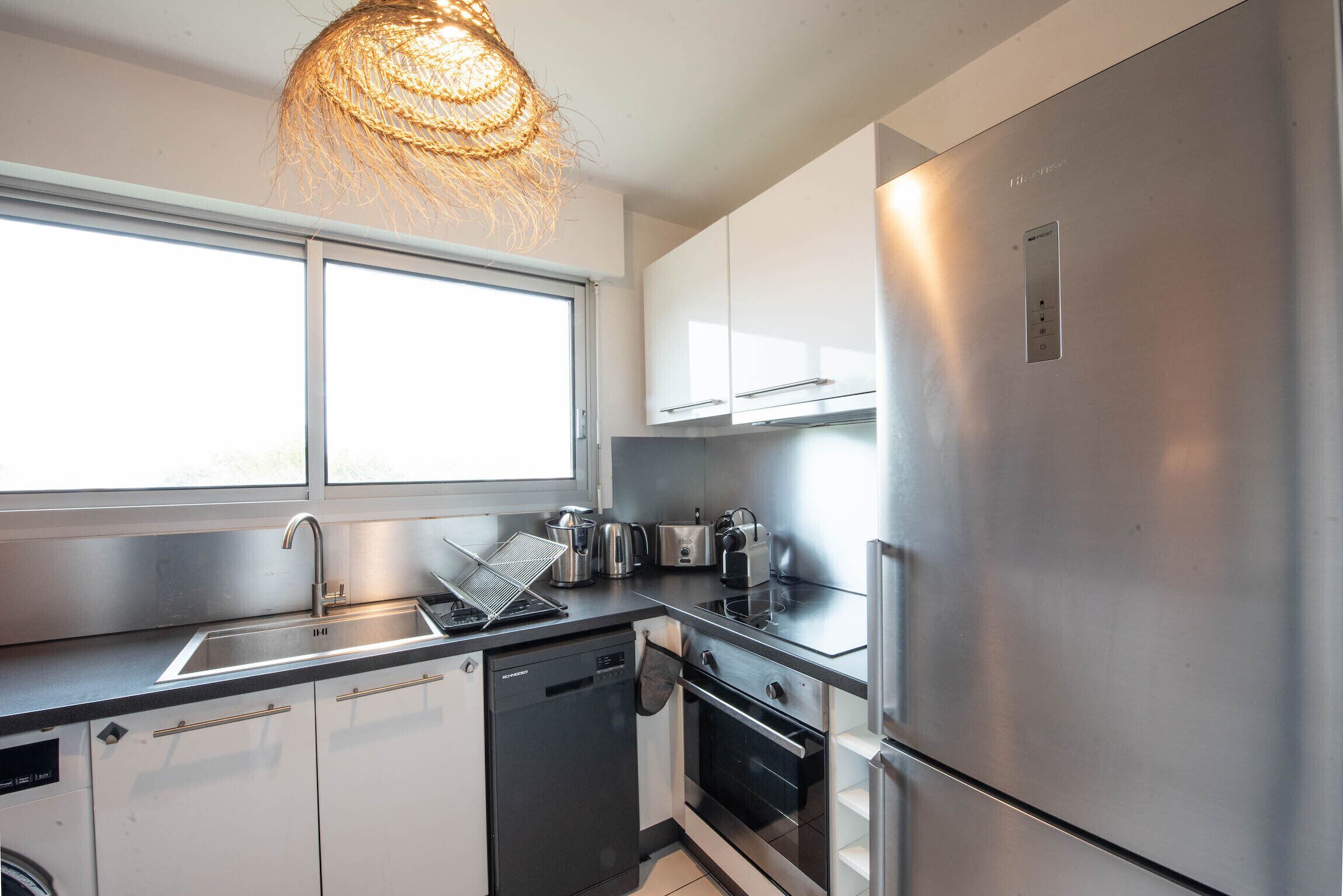 A modern kitchen with stainless steel appliances, a dishwasher, and a built-in oven.