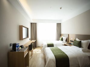 A hotel room with two beds, a desk, and a chair. - Greentree Inn Ankang Middle Bashan Road Business Hotel (Ankang)