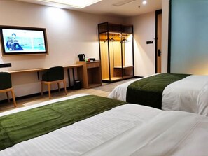 A hotel room with two beds, a desk, a chair, a TV, and a wardrobe. - Greentree Inn Ankang Middle Bashan Road Business Hotel (Ankang)