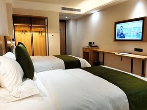 A hotel room with two beds, a TV, a desk, and a wardrobe. - Greentree Inn Ankang Middle Bashan Road Business Hotel (Ankang)